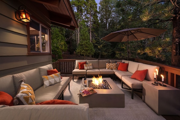 Enjoy the enchanting outdoor forest lounge with firepit and seating for 12