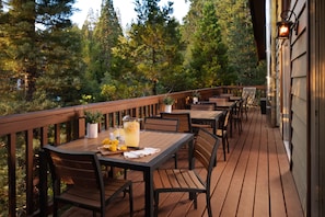 Dine amongst the tree tops in small groups or join tables to host a party of 12