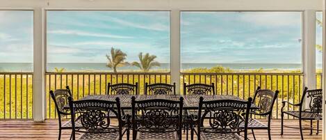 Expansive patio overlooking the Gulf of Mexico with seating for eight guests