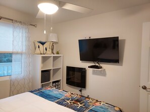 Bedroom with fireplace and TV
