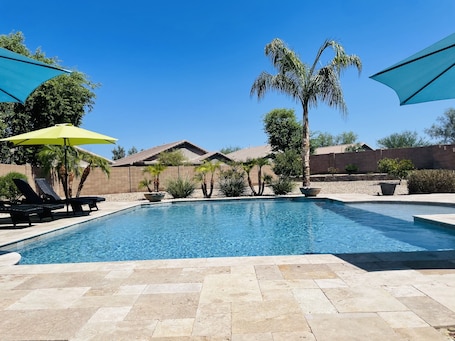 Your private pool oasis, featuring lounge chairs and ample seating.
