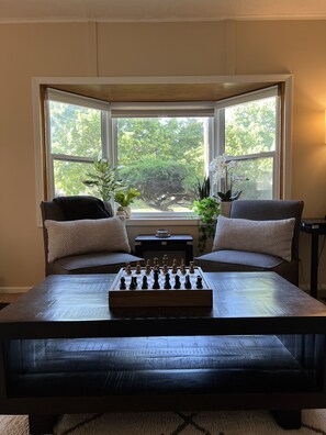 Relax and play a game of chess or checkers in front of the bay window 