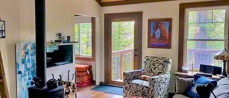 Living room with wood stove, comfortable sofa and chairs