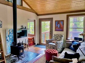 Living room with wood stove, comfortable sofa and chairs