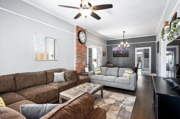 As you enter, you are warmly welcomed by the living area, an inviting common space where everyone can comfortably gather.