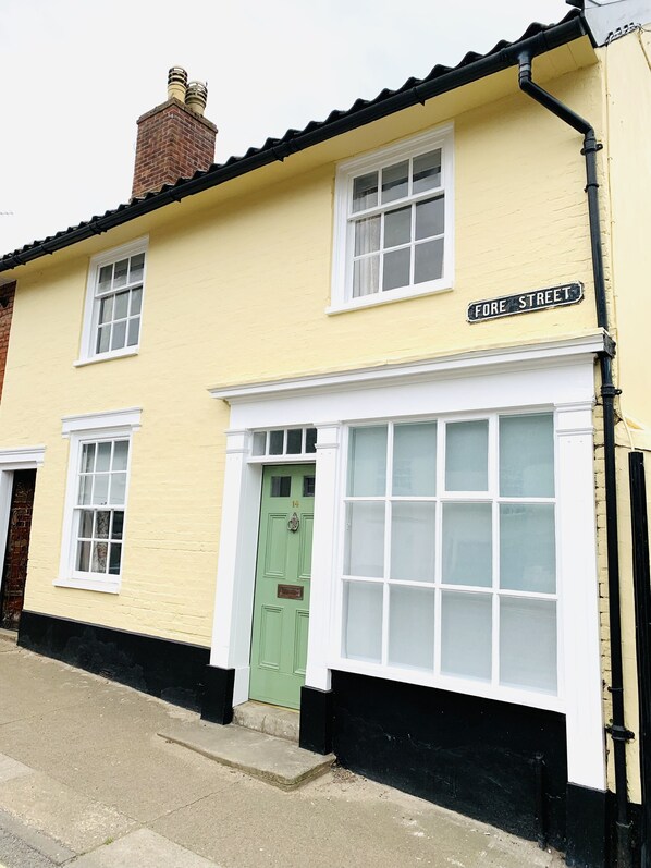 The yellow cottage on the hill