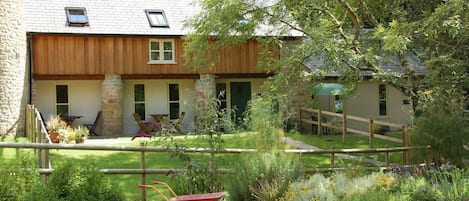 Enclosed private garden area with a stream running past the boundary fence