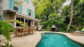 The private backyard is spacious and features a heated pool...