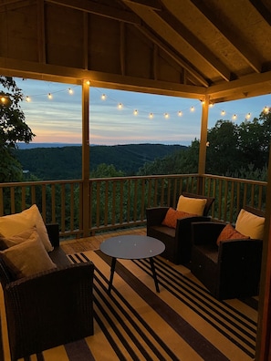 The covered porch is a favorite spot to take in the surrounding nature