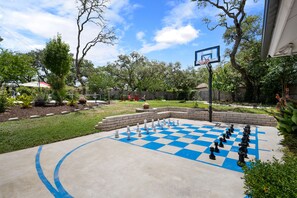 The perfect basketball court! Adjust the goal to any height to accommodate any age group or ability. Tired of shooting hoops, just grab the oversized chess pieces for a healthy (and active) game of chess! The perfect place for any age. 