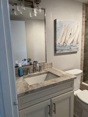Newly remodeled second full bathroom with shower/tub combo. 