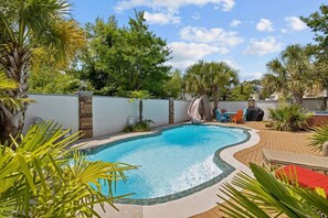 Here's what you came for... endless fun in the private backyard boasts a pool with slide, hot tub, grill, and outdoor cabana.