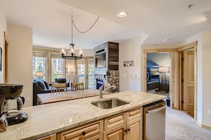 Kitchen with new stainless steel appliances and natural stone countertops