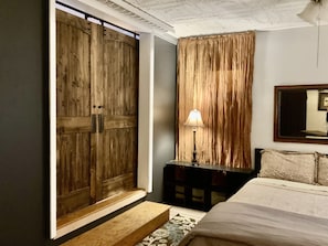 Barn doors in Large bedroom with @ queen beds and a couch for sleeping