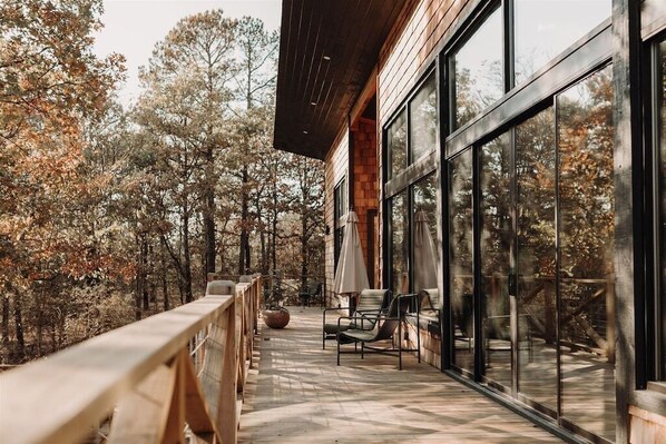 Deck Retreat: Breathe in the fresh air while lounging on your spacious deck amidst the trees!