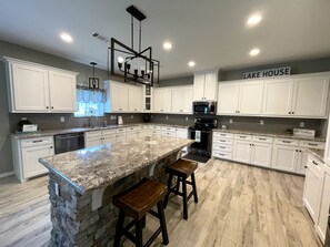 Bar stools and granite countertops to help with food prep & serving.