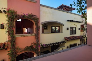 Looking towards the porch and entrance from across the courtyard. 4C is a top 3rd floor condo