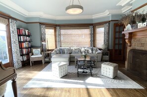 Formal living room with Sony TV and Steinway upright piano and bookcases.  