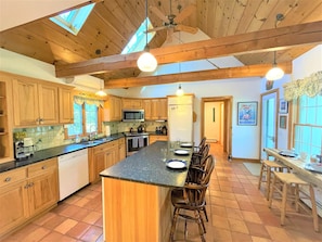 Huge kitchen with wine cooler, two refrigerators, new stove, and massive pantry