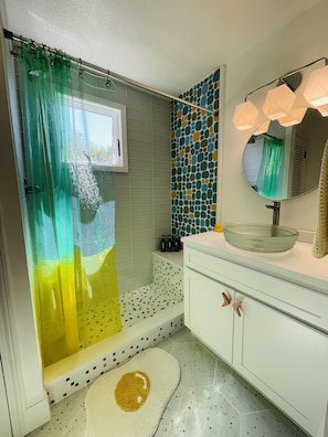 Bathroom, or should I say spa! Walk-in shower w/bench, beach glass vessel sink.