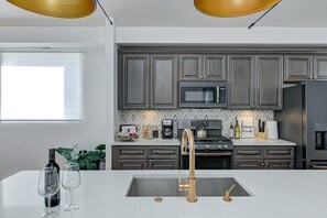 Full kitchen with brand new appliances to prepare meals.  Gas oven-range, microwave, dishwasher, disposal, and French door refrigerator.