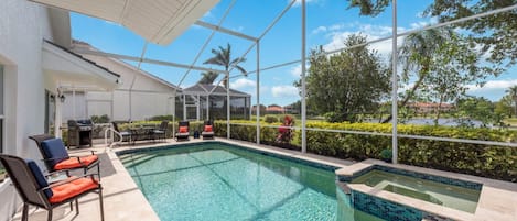 Screened pool with jacuzzi.