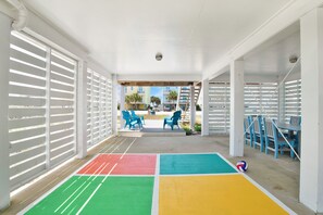Shaded fun with dining, games & comfy lounge chairs—rain or shine