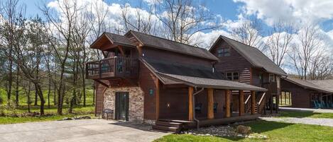 Entrance with picturesque backdrop of amazing mountain views, a bubbling creek, and trees