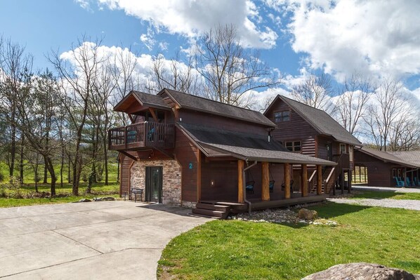 Entrance with picturesque backdrop of amazing mountain views, a bubbling creek, and trees