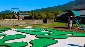Community Mini-golf, playground, sports court a grassy meadow away.