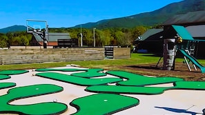 Community Mini-golf, playground, sports court a grassy meadow away.