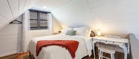 Romantic King bed in upstairs loft area. Hide away and  read a book,  or catch up on emails at the work area desk.