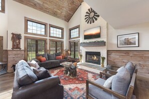 Cozy fireplace with seating for all to enjoy in the living room.