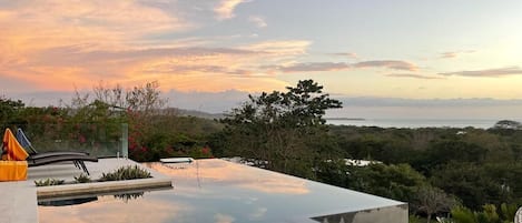 Sunset pool view with Tamarindo in the distance.