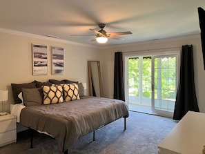 Master bedroom with king sized bed and screened in porch