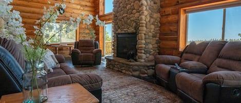 Family room with lounging chairs, gas fire place, and views from all sides.