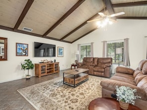Cozy living room with 65" TV, and Roku.