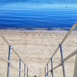 Stairs to beach from common area at low tide