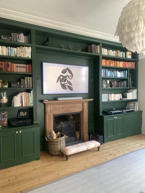 Second living room full of books, toys and games and a huge sofa for relaxing