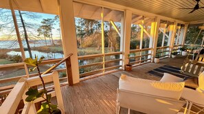 The porch is situated for extraordinary views of the boat basin, the bay, and the sunset.