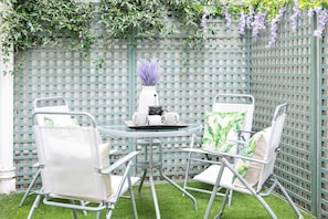 Relax outdoors on the patio with table for dining al fresco.