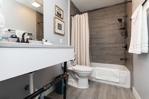 Full bathroom with toiletries, feminine kit, blow dryer, and other amenities.