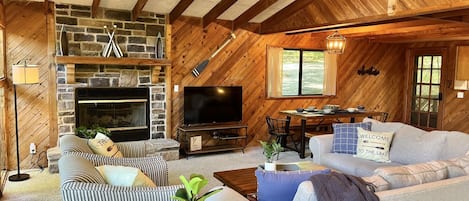 Family room with Roku TV, DVD player and stone fireplace