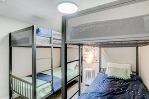Make your kids happy in this basement room with two bunk beds. It’s a cozy and fun space for them to sleep and play. They’ll never get bored here. Sit back, relax, and enjoy the harmonious blend of comfort, style, and natural beauty in this exquisite