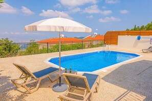 Sunbeds and shade around pool