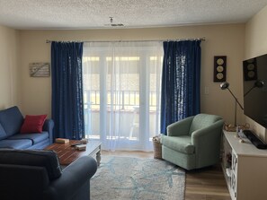 The living room has access to the balcony with amazing ocean views