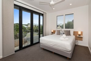 The primary bedroom features a queen bed, walk-in wardrobe, ensuite and a balcony with serene dune views.