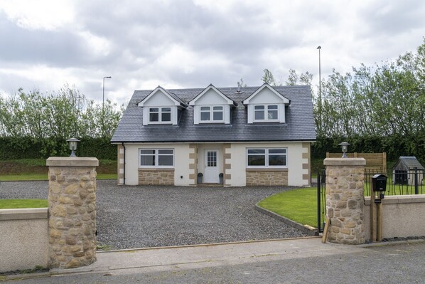 Large detached property accessed through electric gates