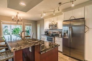 Kitchen island features additional seating for meals and snacks