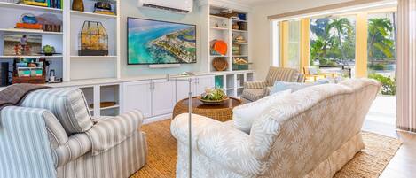 Comfy living area with screened porch in the background. 